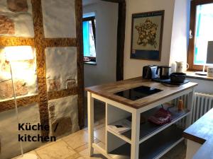 a kitchen with a wooden counter in a room at Ferienwohnung VISHWAS in Trier