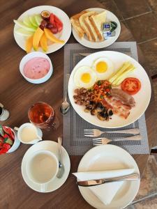 a table with plates of breakfast food on it at Serurubele Boutique Hotel in Bushbuckridge