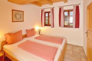 a bedroom with two beds and two windows at Wellness Chalupa Theo in Vrchlabí