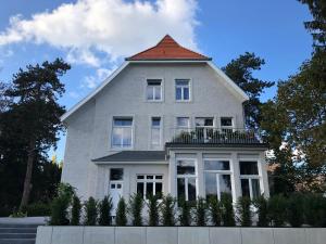 a large white house with an orange roof at Villa Glanzstoff in Heinsberg