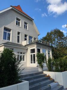 a large house with stairs in front of it at Villa Glanzstoff in Heinsberg