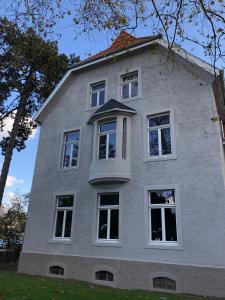 a house with white windows on the side of it at Villa Glanzstoff in Heinsberg