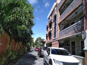 a street with cars parked on the side of a building at V.F. Riton Apartelle in Laoag