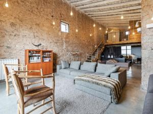 a living room with a couch and a chair at Belvilla by OYO Cottage Fraga in Torrente de Cinca
