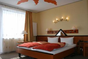 Postel nebo postele na pokoji v ubytování Dünenhotel Borkum