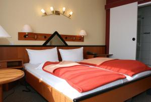 Postel nebo postele na pokoji v ubytování Dünenhotel Borkum
