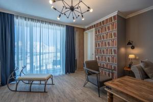 a living room with a chandelier and a table and chairs at Deer Valley - New Gudauri in Gudauri