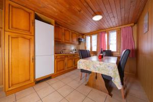 a kitchen with a table and chairs in a room at Haus Amour in Saas-Grund