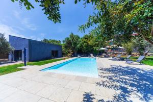 a swimming pool in a yard with chairs and trees at I Pittaneri in Catania