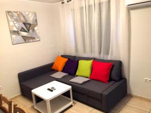 a couch with colorful pillows in a living room at Cosy flat with excellent location in Valencia! in Valencia