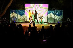 a group of people on a stage in front of a screen at Tamarit Beach Resort in Tamarit