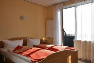 Postel nebo postele na pokoji v ubytování Dünenhotel Borkum