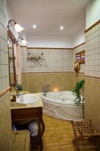 a bathroom with a bath tub and a sink at Amazing Country House with Ocean View, Cueva de la Arena in Garachico