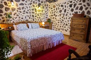 a bedroom with a bed with a leopard print wall at Amazing Country House with Ocean View, Cueva de la Arena in Garachico