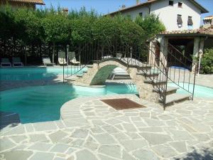 a swimming pool with a staircase next to a house at Monastery Guest House in Lerchi