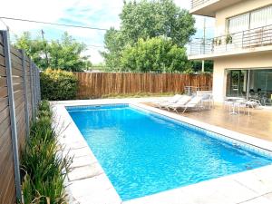 a swimming pool in the backyard of a house at Departamento Alassio in Tigre