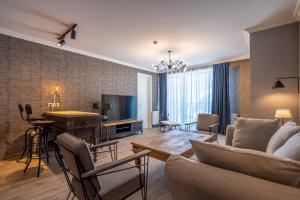 a living room with a couch and a television at Deer Valley - New Gudauri in Gudauri