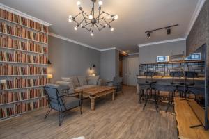 a living room with a couch and a table and books at Deer Valley - New Gudauri in Gudauri