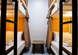 a room with two bunk beds and a table at B&B Backpackers in Coron