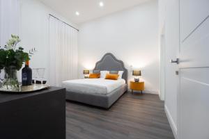 a bedroom with a bed with orange pillows at Suite Rodinò 24 in Naples +8 photos