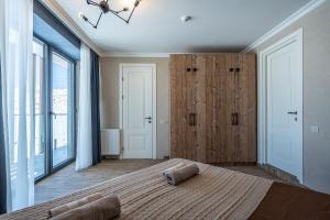 a bedroom with a large bed and a large window at Deer Valley - New Gudauri in Gudauri