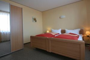 Postel nebo postele na pokoji v ubytování Dünenhotel Borkum