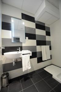 a bathroom with a black and white striped wall at Day's Inn Hotel and Residence in Sliema