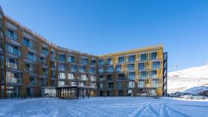 a large building with snow in front of it at Deer Valley - New Gudauri in Gudauri