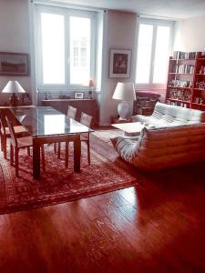 a living room with a couch and a table at La Bisontine in Besançon