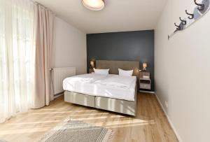 Ein Bett oder Betten in einem Zimmer der Unterkunft Hotel- & Ferienanlage Kapitäns-Häuser Breege