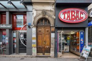 a large wooden door in the front of a store at Honorê - Suite Barre in Lyon +6 photos