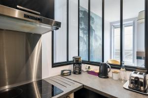 a kitchen with a counter with a coffee maker on it at Honorê - Suite Barre in Lyon
