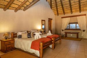 a bedroom with two beds in a room at Ondundu Lodge in Kamanjab
