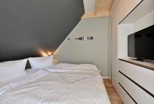 Ein Bett oder Betten in einem Zimmer der Unterkunft Hotel- & Ferienanlage Kapitäns-Häuser Breege