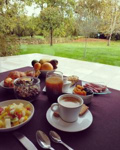 a table topped with plates of food and cups of coffee at Hôtel de la Marine in Saint-Herblain