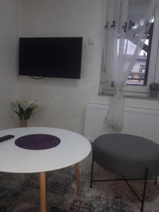 a living room with a white table and a chair at Apartman Mango Banja Luka center hospital Free parking in Banja Luka