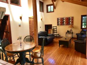 a living room with a table and a couch at YAN KEE WAY LODGE BUNGALOW in Puerto Varas