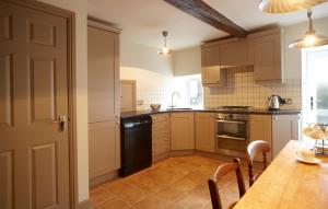 a kitchen with a wooden table and a dining room at Chapel Cottage Set in a private courtyard in central location with 2 parking spaces in Kirkby Lonsdale +34 photos