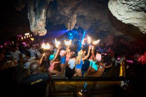 a group of people in a cave with torches at Las Terrazas Condo Punta Cana Beach - Los Corales Village in Punta Cana +101 photos