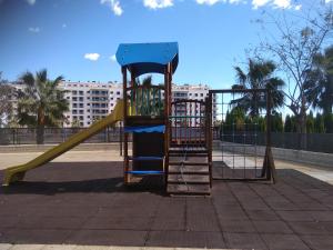 a playground with a slide in a park at Apartamento Moncofar playa in Moncófar