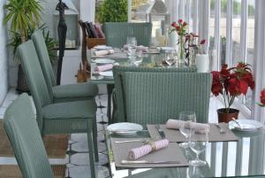 a dining room with a table with green chairs at The Airds Hotel and Restaurant in Port Appin