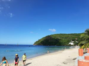a group of people walking on the beach at Les Monts Arl&eacute;sien in Les Anses-dʼArlets