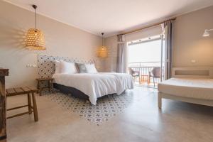 a large white bed in a room with a large window at Marble Stella Maris Ibiza in San Antonio