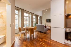 a kitchen and dining room with a table and chairs at RS Porto Historic Center in Porto