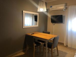 a dining room table with two chairs and a window at Apartment Lam62 in Bahía Blanca