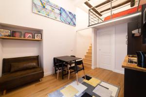 salon ze stołem i kanapą w obiekcie Design Studio Flat Next Sorbillo on Tribunali St By HouseinNaples w mieście Neapol