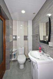 a bathroom with a white toilet and a sink at Apartment near Sasundci Davit Metro Station in Yerevan