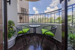 a balcony with a table and two chairs at Edmor Residences Riverside in Nairobi