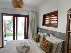a bedroom with a bed with two towels on it at Pousada Tartaruga Boutique Hotel in Pipa +57 photos