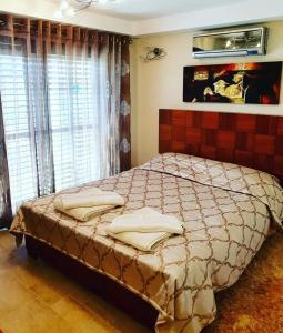 a bedroom with a large bed in front of a window at Kalypso View Apartments in Letimbou +44 photos